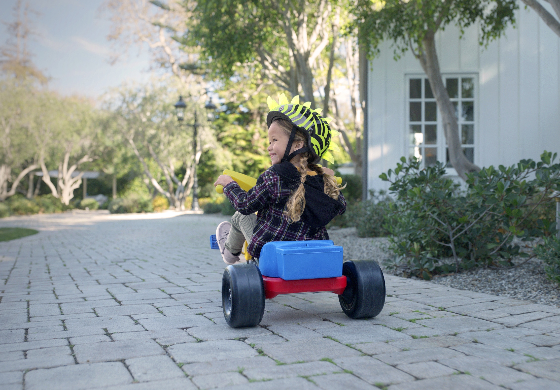 Child on Tricycle Smiling